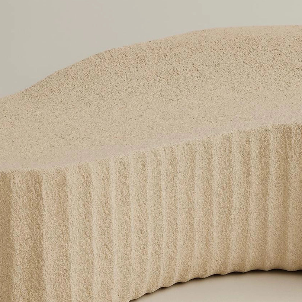 Close-up of the flowing stone seat and textured side of the Unda Bench by Andres Monnier