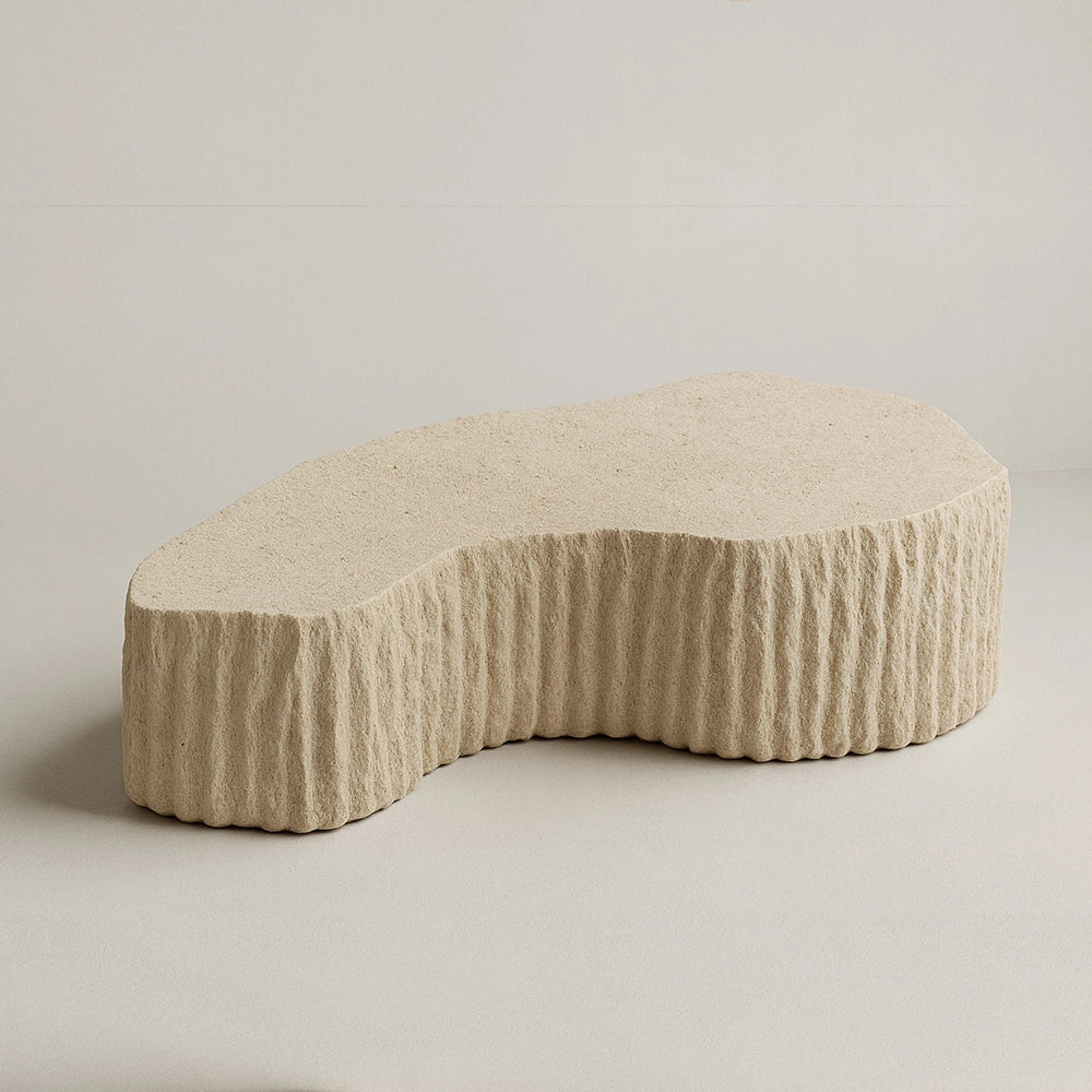 Estria travertine coffee table by Andres Monnier with an organic top and deeply carved vertical sides.