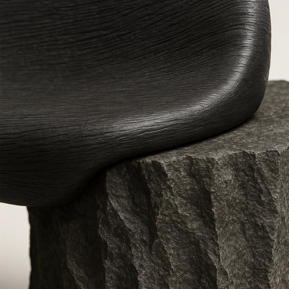 Close-up of the smooth walnut seat meeting the raw onyx base of the Silva Bench.