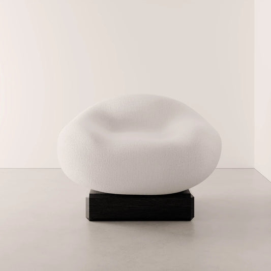 Front view of the Winter Powder Chair by Antony Gasnier with a rounded white seat and dark solid oak base