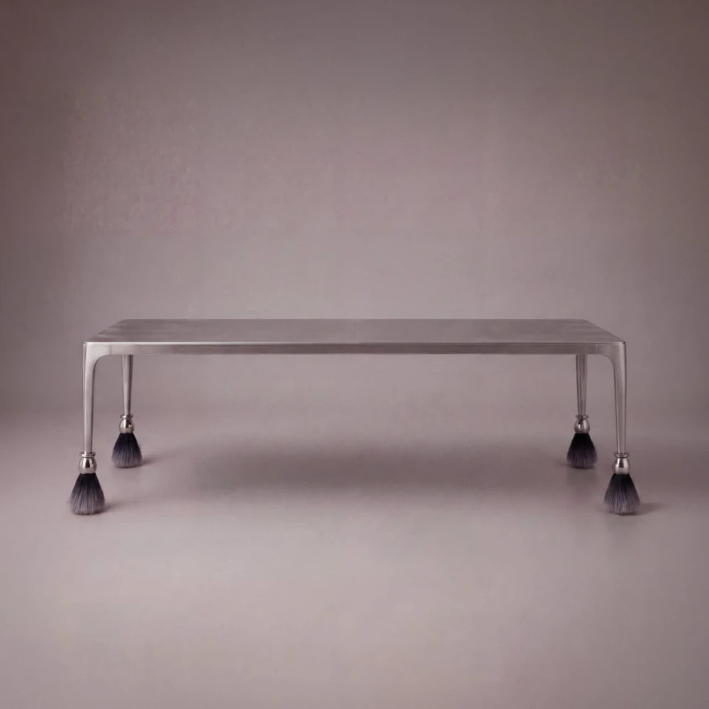 Product view of the rectangular Pompon dining table by Diamant Versatile, featuring a brushed metal frame and tassel-tipped legs.