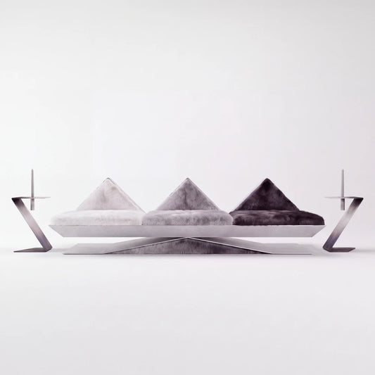 Front view of the Vertice sofa by Diamant Versatile, with three geometric fur seats resting on a faceted brushed metal base.