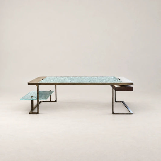 DK01 Desk by Eva Szumilas, with a textured pale turquoise glass top, bronze-toned metal frame, matching lower glass shelf and dark wooden drawer.