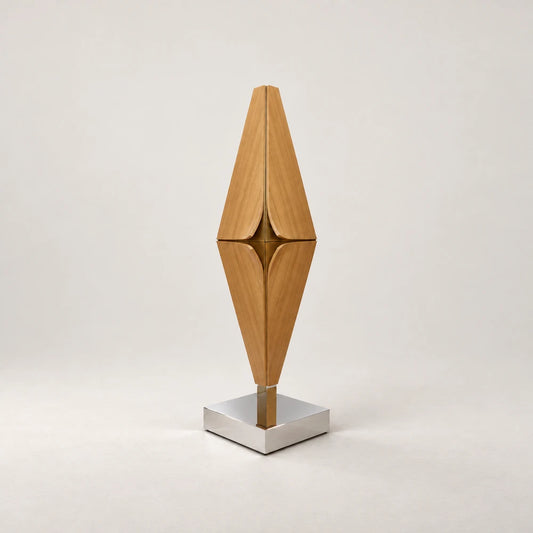 Diamond Bar Cabinet by Eva Szumilas, with a tall diamond-shaped wooden body, curved door edges, gold-toned central detailing and a polished square metal base.