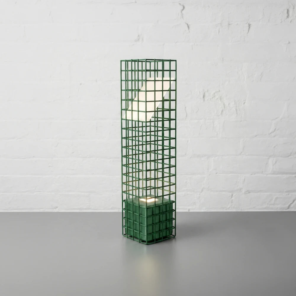 Three-quarter view of the green Ami Desk Lamp by Garnier Pingree, showing its open metal grid, square base and angled luminous panel.