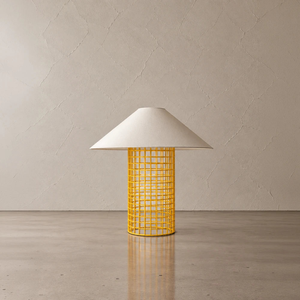 Yellow Ento Table Lamp by Garnier Pingree, with a bright cylindrical metal grid base supporting a wide cream conical shade.