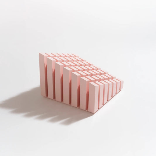 Pink Cinquante decorative object by Malvin Gaborit, with a stepped grid of vertical elements, three-quarter view.