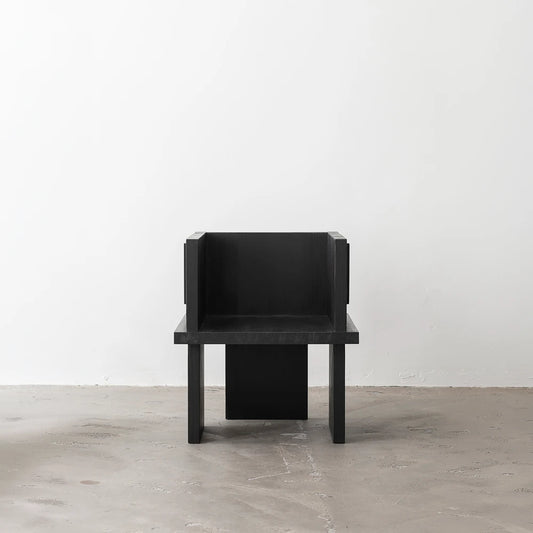 Full front view of the Itooraba Chair Black by Sizar Alexis, emphasizing its compact proportions and burned solid pine structure.