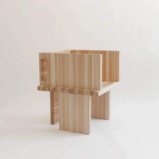Itooraba Chair by Sizar Alexis presented against a neutral background, highlighting its natural pine grain and architectural construction.