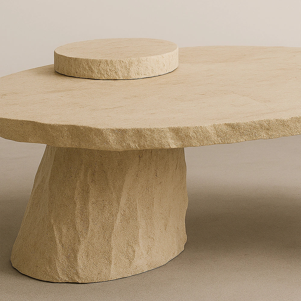 Close-up of the raised circular element and travertine surface of the Cenote Dining Table.