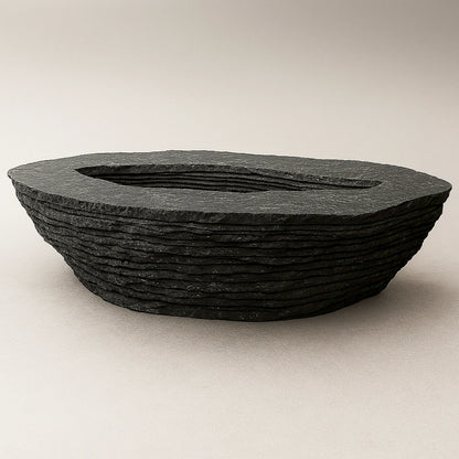 Einros black marble coffee table by Andres Monnier with layered circular forms around a central void.