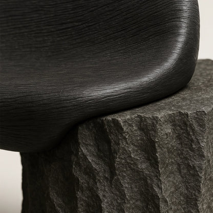 Close-up of the smooth walnut seat meeting the raw onyx base of the Silva Bench.