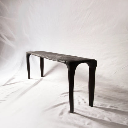 Eclipse console in hand-carved and charred reclaimed oak by Antoine Maurice, shown with its four tapered legs