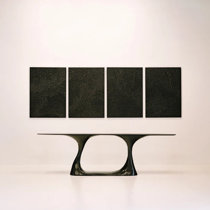 Invitation console by Antoine Maurice displayed beneath four textured black wall panels in a minimal interior