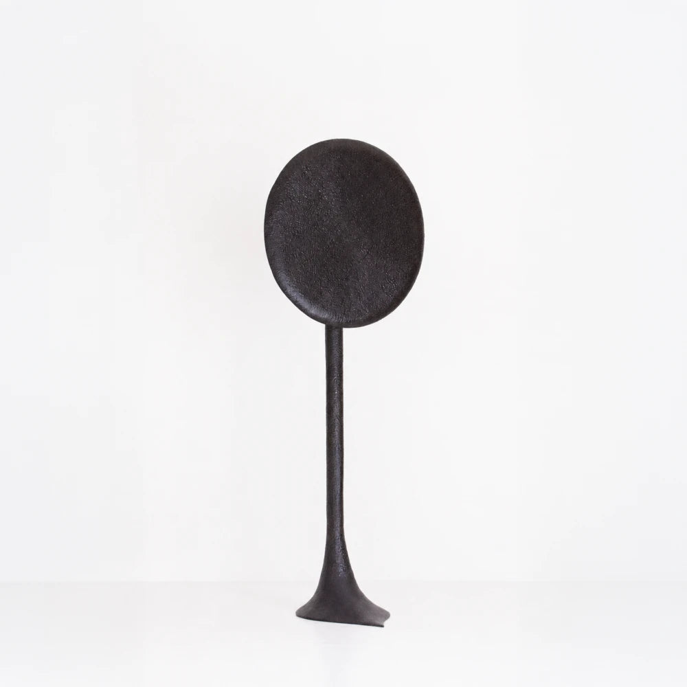 Solis floor lamp handcrafted in textured walnut by Antoine Maurice, with a tall stem and large dark oval disc
