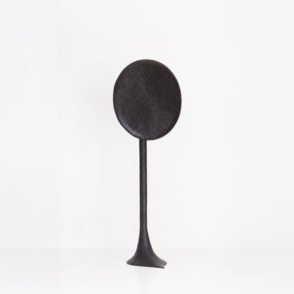 Solis floor lamp handcrafted in textured walnut by Antoine Maurice, with a tall stem and large dark oval disc