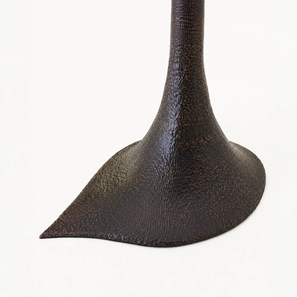 Close-up of the hand-carved walnut texture and flared base of the Solis floor lamp by Antoine Maurice