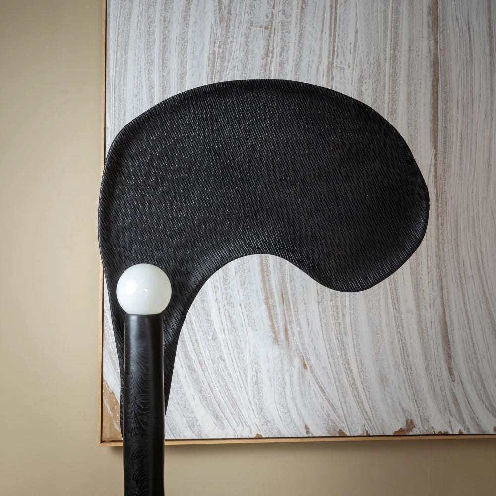 Front close-up of the hand-carved textured oak form and spherical light of the Spectre floor lamp by Antoine Maurice