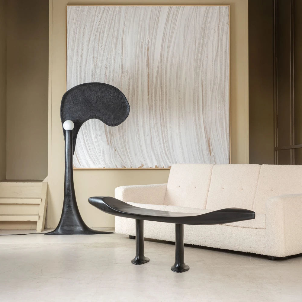 Spectre floor lamp by Antoine Maurice displayed beside the Orphée bench and a cream sofa in a contemporary interior