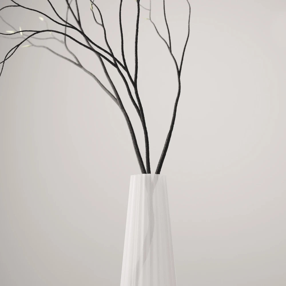 Close-up of the fluted frosted white Alta Vase by Antony Gasnier holding tall dark branches