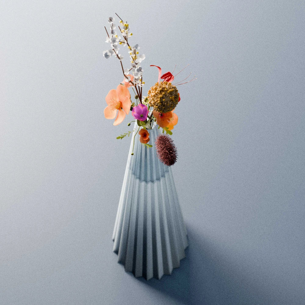 Blue-grey Alta Vase by Antony Gasnier with a colourful bouquet, highlighting its tall tapered and fluted form