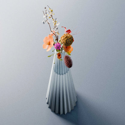 Blue-grey Alta Vase by Antony Gasnier with a colourful bouquet, highlighting its tall tapered and fluted form