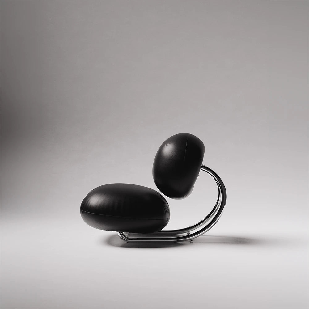 Side profile of the C8 Armchair by Antony Gasnier, highlighting its circular chrome frame and suspended leather cushions