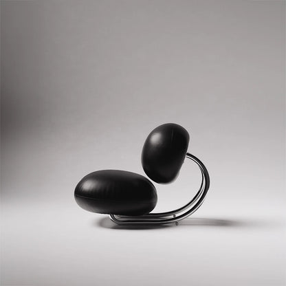 Side profile of the C8 Armchair by Antony Gasnier, highlighting its circular chrome frame and suspended leather cushions