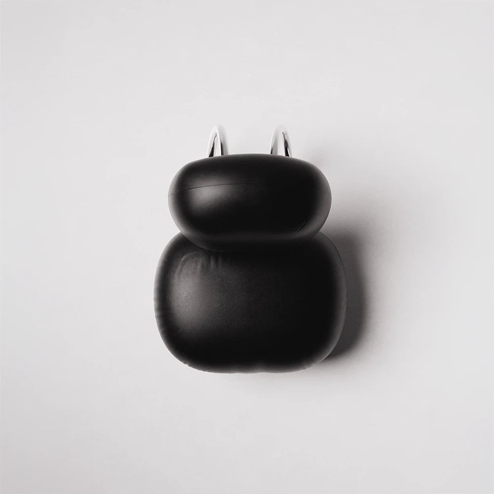 High-angle view of the C8 Armchair by Antony Gasnier showing its black leather upholstery and curved chrome structure