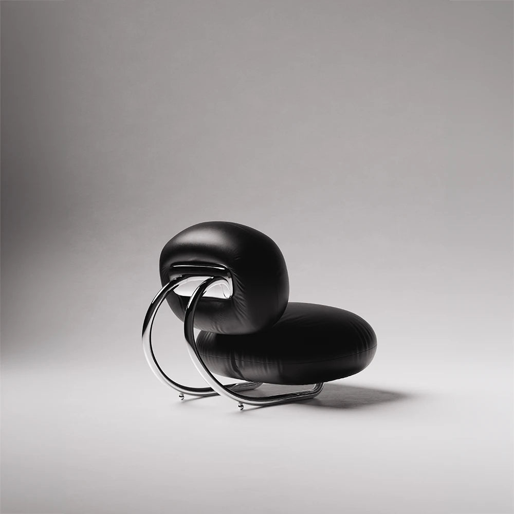 Opposite rear view of the C8 Armchair by Antony Gasnier with black leather upholstery and looping chrome supports