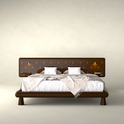 Front view of the Will Bed by Antony Gasnier with a wide inlaid headboard, integrated tables and reading lights
