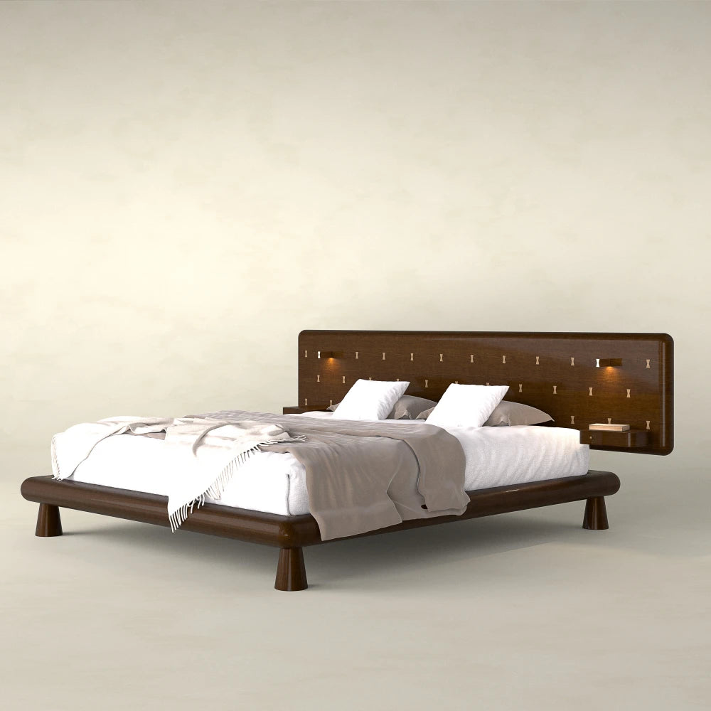 Three-quarter view of the Will Bed in dark wood by Antony Gasnier with a rounded frame and integrated headboard