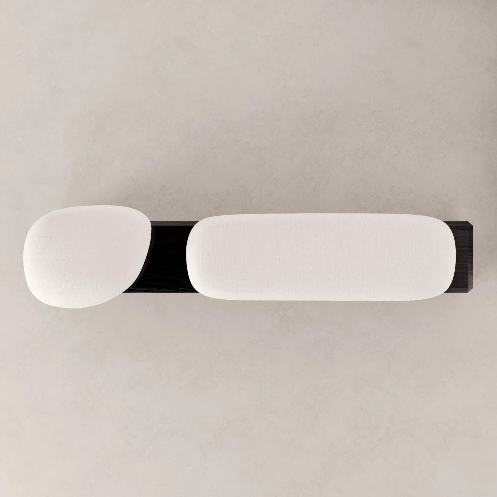 High-angle view of the Winter Bench by Antony Gasnier, showing its two sculpted white cushions and rectangular oak base