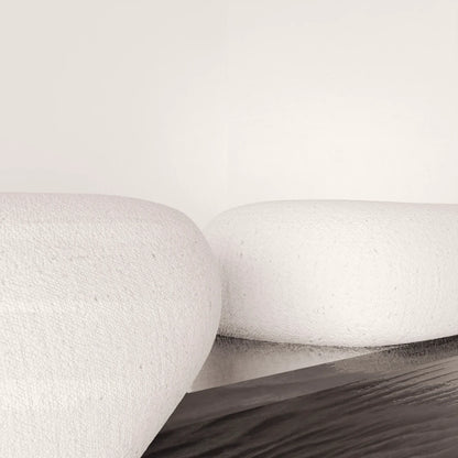 Close-up of the textured white upholstery and dark solid oak structure of the Winter Bench by Antony Gasnier