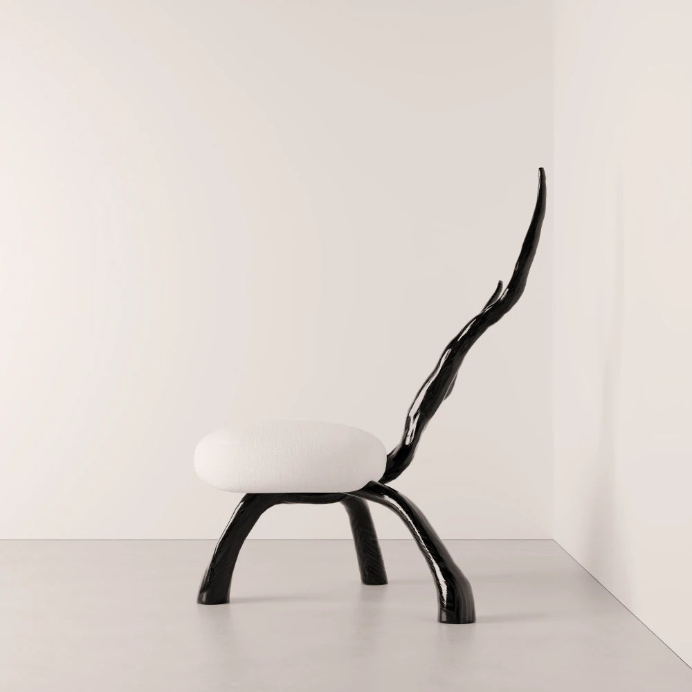 Side view of the Winter Branch Chair by Antony Gasnier, highlighting its elongated branch-like solid oak backrest