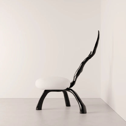 Side view of the Winter Branch Chair by Antony Gasnier, highlighting its elongated branch-like solid oak backrest