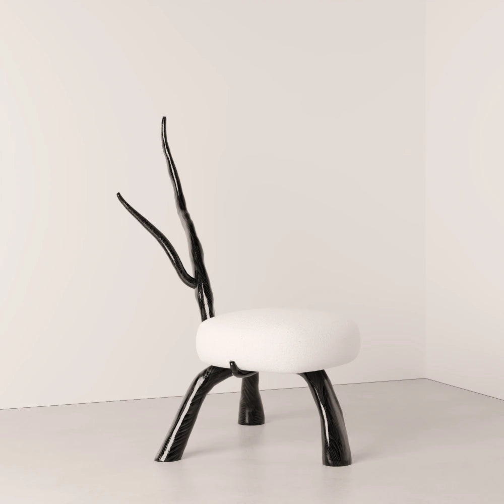 Three-quarter view of the Winter Branch Chair by Antony Gasnier, showing its sculptural oak legs and rounded white seat