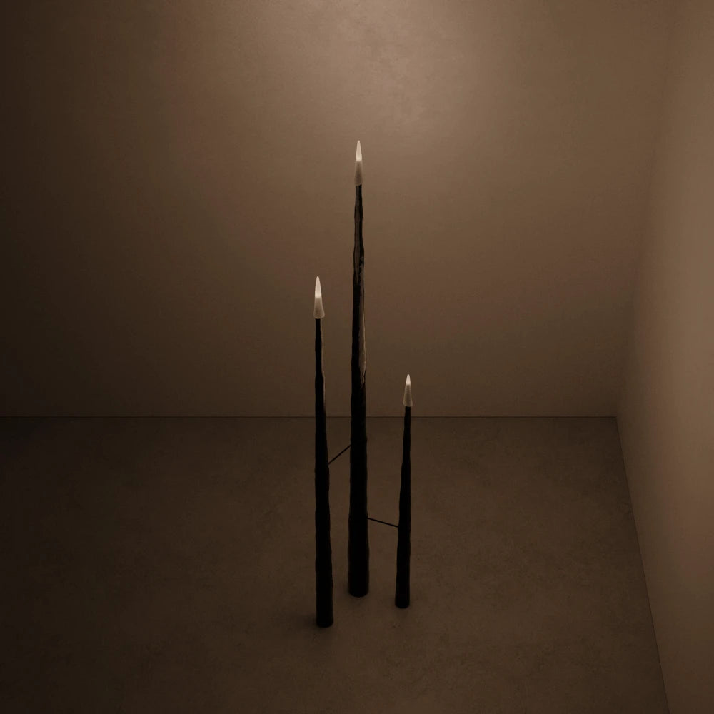 High-angle view of the illuminated Winter Candle set in blackened wood by Antony Gasnier