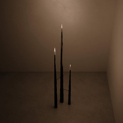 High-angle view of the illuminated Winter Candle set in blackened wood by Antony Gasnier