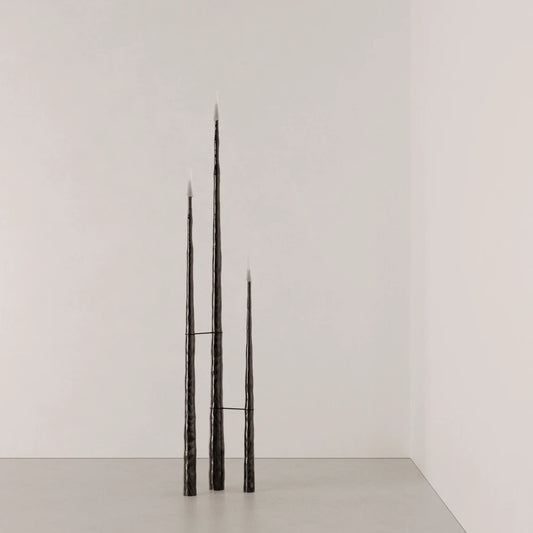 Full view of three Winter Candle holders in blackened wood by Antony Gasnier against a neutral background