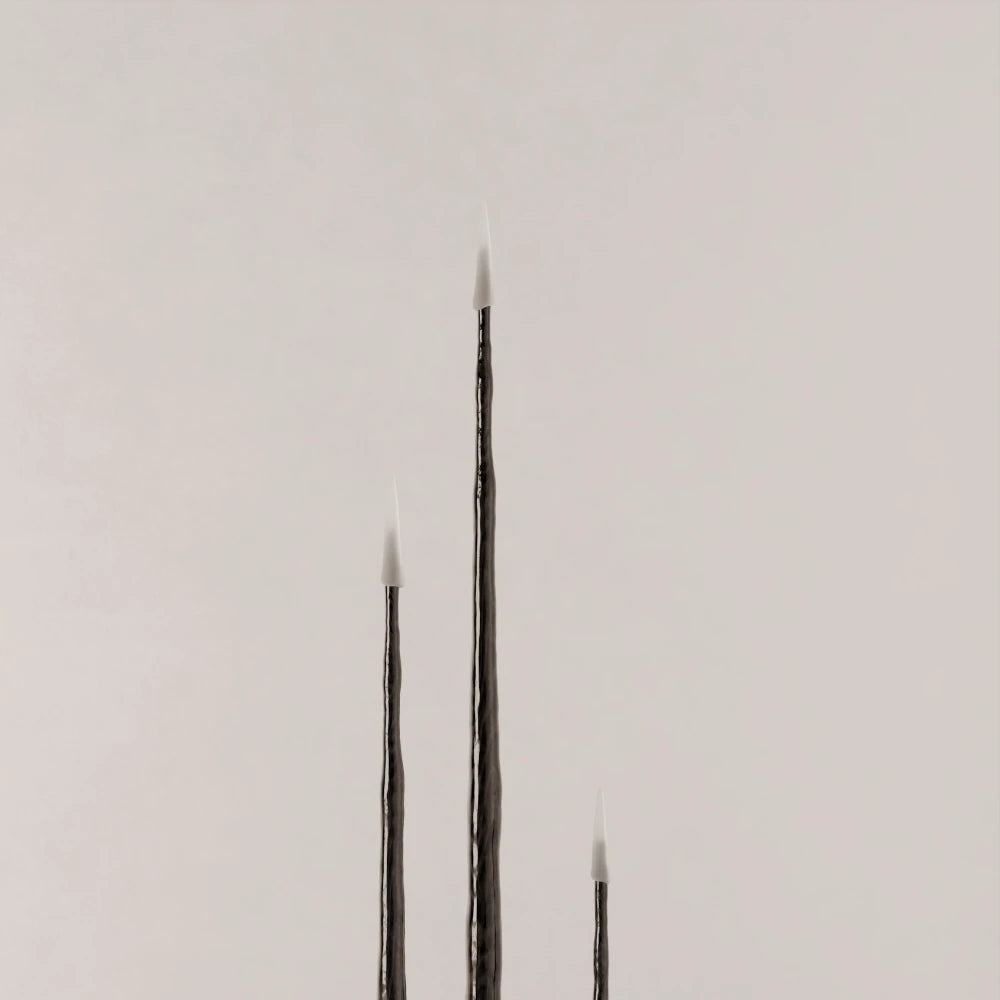 Close-up of three Winter Candle holders in blackened wood by Antony Gasnier, shown at varying heights