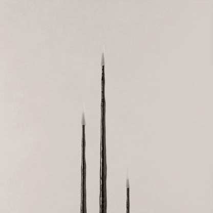 Close-up of three Winter Candle holders in blackened wood by Antony Gasnier, shown at varying heights