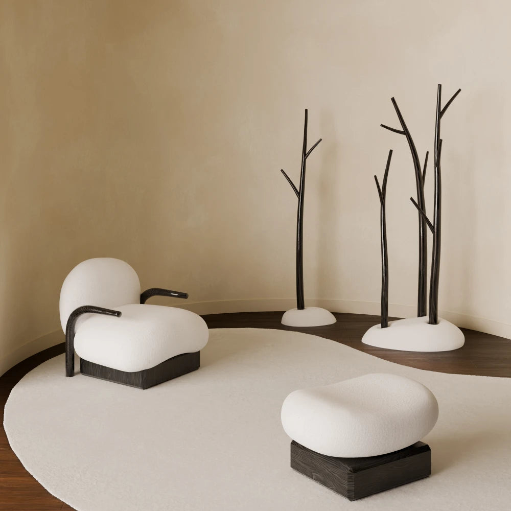 Winter Collection by French designer Antony Gasnier, featuring a handcrafted armchair, ottoman and sculptural tree-inspired pieces available at Lythore