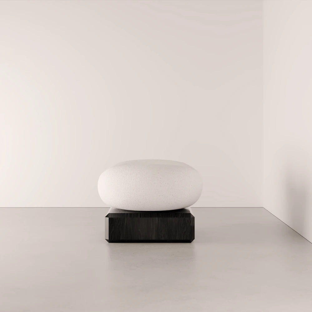 Front view of the Winter Ottoman by Antony Gasnier with a rounded white fabric seat and rectangular dark oak base
