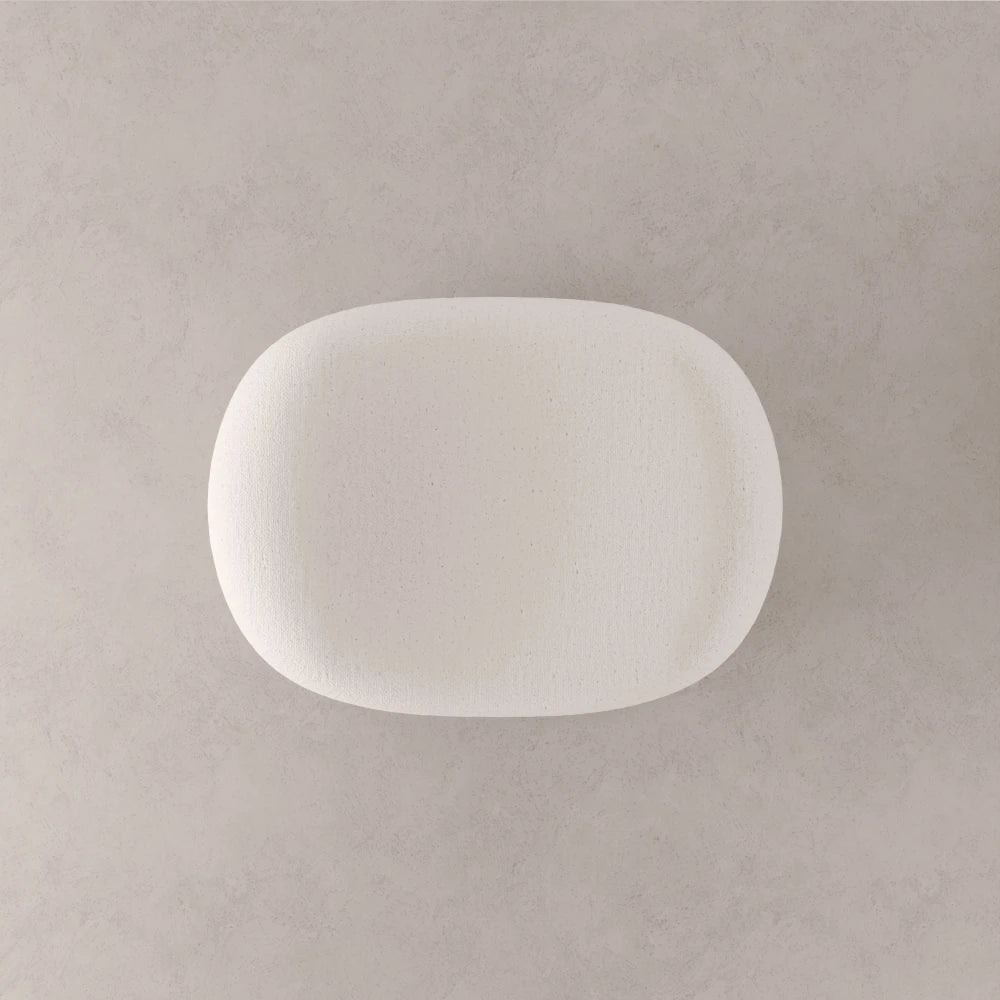 Top view of the Winter Ottoman by Antony Gasnier, highlighting the softly hollowed centre of its white upholstered seat