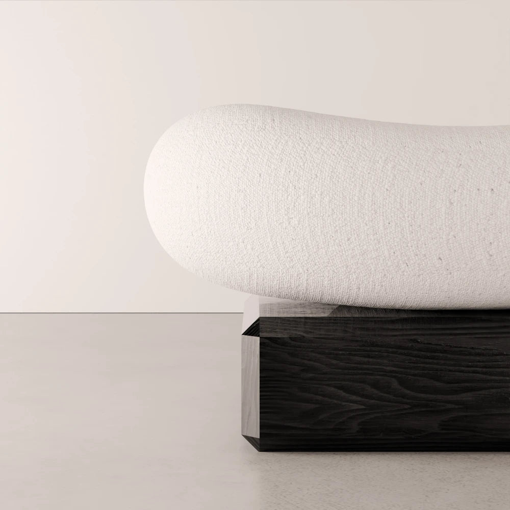 Close-up of the textured white upholstery and dark solid oak base of the Winter Ottoman by Antony Gasnier