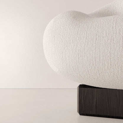 Close-up of the textured white fabric and dark solid oak base of the Winter Powder Chair by Antony Gasnier