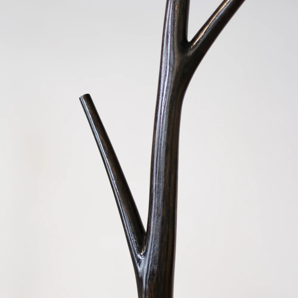 Close-up of a branch junction on the dark wood Winter Tree coat stand by Antony Gasnier