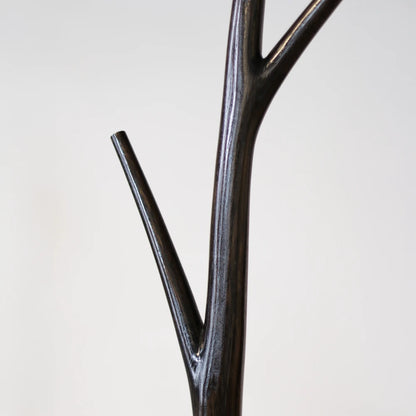 Close-up of a branch junction on the dark wood Winter Tree coat stand by Antony Gasnier