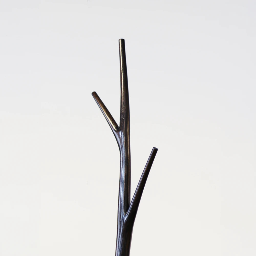 Upper detail of the Winter Tree coat stand by Antony Gasnier showing its three tapered dark wood branches